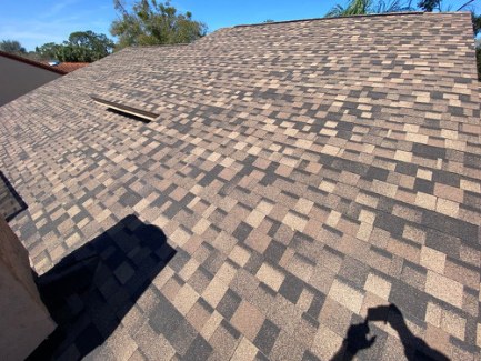 Completed architectural shingle roof planes and ridge lines in Southwest Orlando