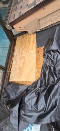 Close view of localized roof decking replacement near a roof transition