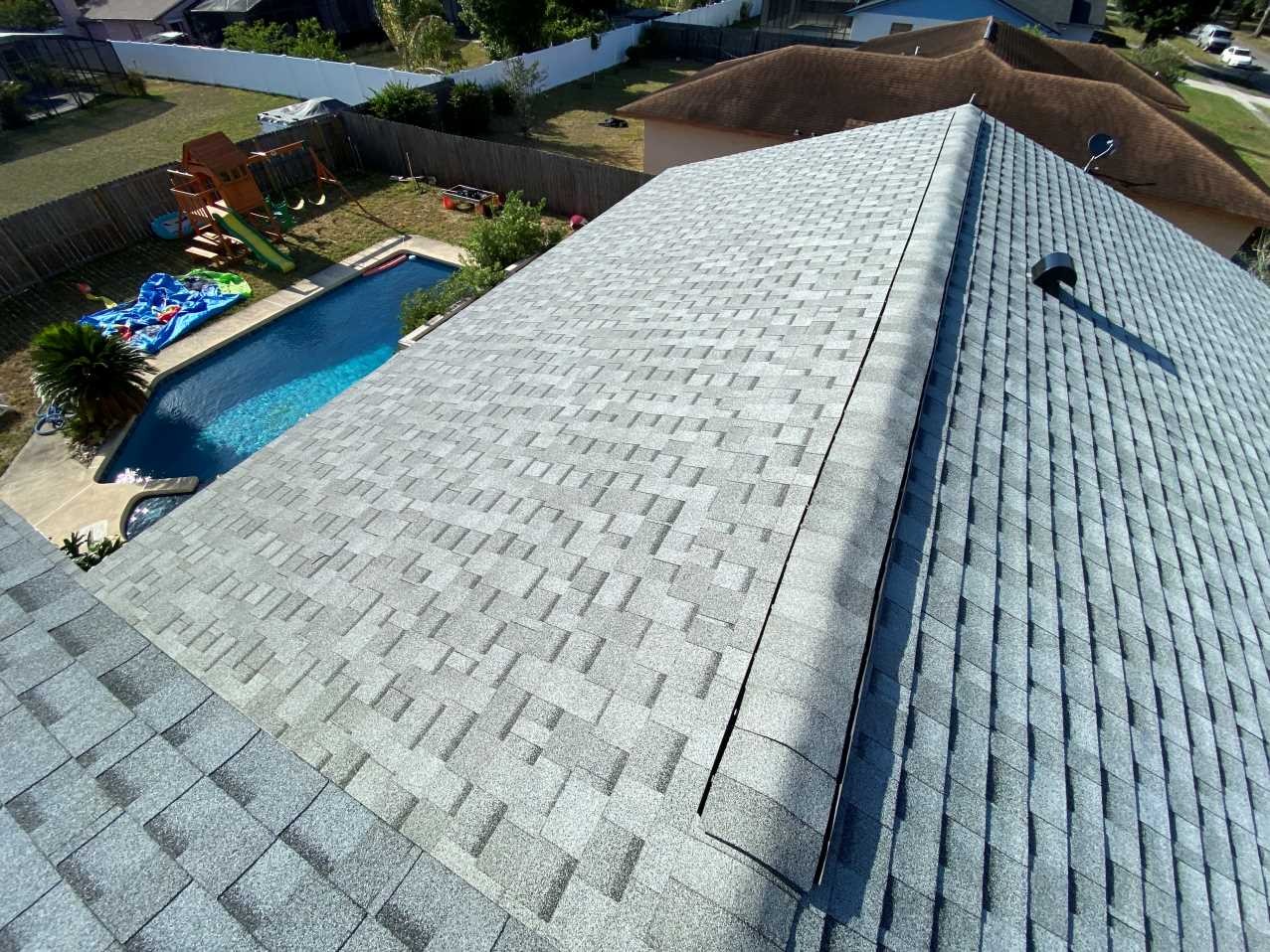 Completed architectural shingle roof with finished ridge lines